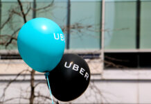 Montreal, Canada - April 29, 2016: A blue and a black balloon are floating outside at a pro Uber rally.
