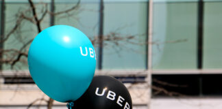 Montreal, Canada - April 29, 2016: A blue and a black balloon are floating outside at a pro Uber rally.
