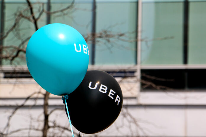 Montreal, Canada - April 29, 2016: A blue and a black balloon are floating outside at a pro Uber rally.