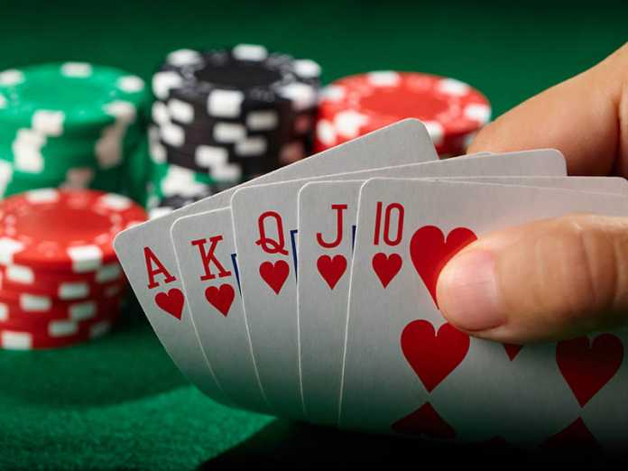 Flush royal in poker player hand. Lucky winner. Poker