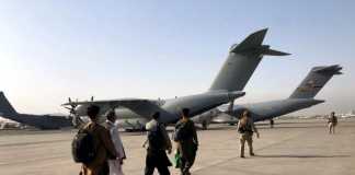 Evacuees board plane