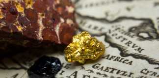 The Jihadi Gold Rush Fuels Violence in the Sahel Region Close-up of ore deposits (gold, coal & bauxite) and an old map of Africa