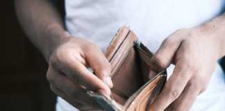 Credit Score Requirement to Buy a Car Man hand open an empty wallet with copy space