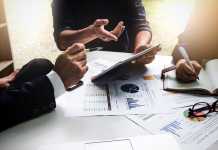 6 Ways to Lower Expenses and Increase Revenue in the Process Business people using pen,tablet,notebook are planning a marketing plan to improve the quality of their sales in the future.