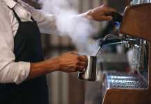 How to Start a Coffee Shop? The Steps You Should Know! Barista making a cup of coffee in machine