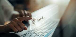 Hand using laptop and press screen to search Browsing on the Internet online.