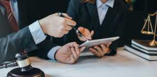 At the meeting, a team of lawyers discussed the lawsuit. Concept of law and justice.
