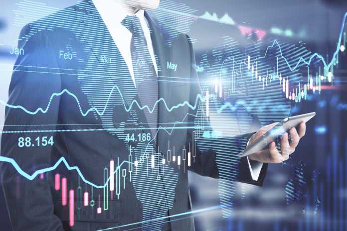 Investment business concept: businessman with smartphone and digital screen with financial chart graphs, candlestick, and diagram