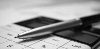 Overview About Sales Commission Calculator Financial accounting with tax documents, pen and calculator. The concept of business and finance.