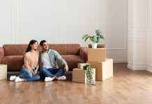 6 Common Mistakes When Buying a House and How to Avoid Them Family relaxing on floor in new home with cardboard boxes
