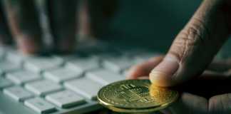 bitcoins and man using computer