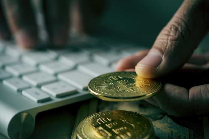 bitcoins and man using computer