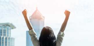 A Global View: 5 Essays from Around the World That Will Change The Way You Think About Women Empowerment Woman power and girl strength in business achievement, winning and career success with strong businesswoman leader in office raising fists with ambition looking forward to city building background