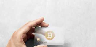 5 Best Crypto Credit Cards 2022 Hand holding bitcoin card template with rounded corners and embossed gold logo. Plain plastic cryptocurrency payment-card display front, design mock up. Electronic mining template.