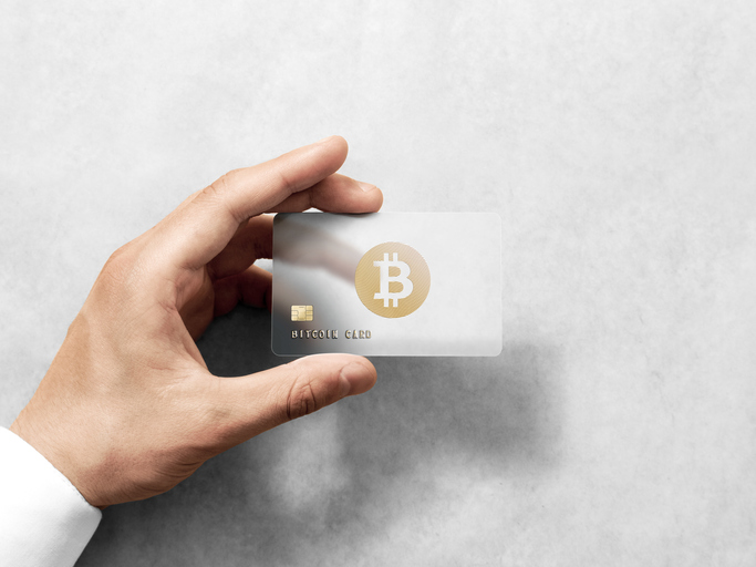Hand holding bitcoin card template with rounded corners and embossed gold logo. Plain plastic cryptocurrency payment-card display front, design mock up. Electronic mining template.