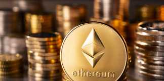 Frankfurt, Hesse, Germany - April 12, 2018: Cryptocurrency coin Ethereum with several stacks of coins in the background