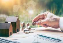Things You Should Know Before Investing in Property House placed on coins Men's hand is planning savings money of coins to buy a home concept concept for property ladder, mortgage and real estate investment. for saving or investment for a house,