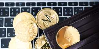 How to Organize Your Own Crypto Wallet Metal golden Ethereum in brown leather wallet on laptop keyboard background. Cryptocurrency concept.