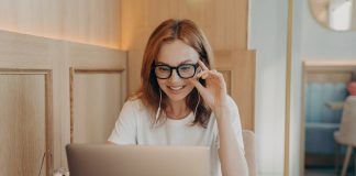 Woman remote worker looks in laptop screen