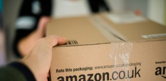 Amazon Warehouse Injury Rates Continue To Top The National Average. Find Out How Woman receiving parcel