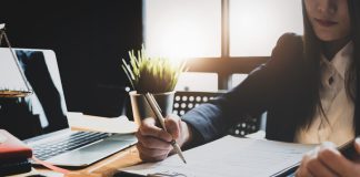 When Do You Need the Services of a Labor Lawyer? law concept, lawyer woman hoding pen with contract or agreement document to customer for signing in courtroom legal.