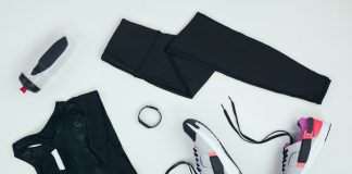 Best and Safest Way to Buy Workout Clothes Online flat lay with sportswear with sneakers, fitness tracker and sports bottle isolated on grey