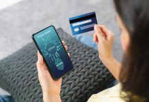 How to Prevent Payments Fraud Woman holding smartphone and credit card with scanning biometric fingerprint for approval to access for payment mobile banking on application wallet.