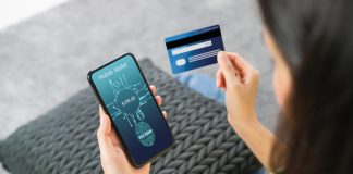 How to Prevent Payments Fraud Woman holding smartphone and credit card with scanning biometric fingerprint for approval to access for payment mobile banking on application wallet.