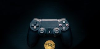 Bitcoin sitting underneath a Playstation 4 Controller
