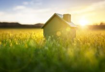 Is Renting A Home The Smart Financial Choice In 2022? Ecological green wood model house in empty field at sunset