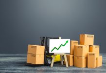 Forklift near boxes and easel with green arrow up. Growth trade and production rates, increased sales. High import export. Economic growth, industry development. Marketing, price increases.