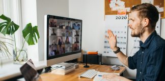 Young man having Zoom video call via a computer in the home offi