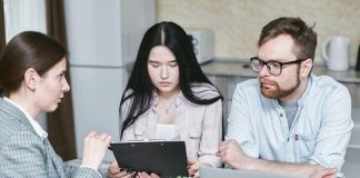 9 Courses You Should Take if You Want to Become a Knowledgeable Investor A couple sits at a table with a consultant discussing a deal