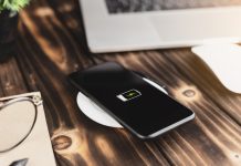 Wireless Charging: Unlocking the Benefits of Cord-Free Power Solutions close-up phone charging on wireless charger device