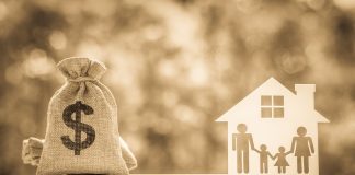 Legacy / inheritance or death tax concept : US dollar bag, a house and family members e.g father, mother, son, daughter on a balance scale, depicts a tax paid by person who inherits money or property.