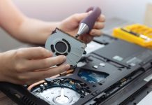 The Cost of Laptop Repair Close up of laptop computer hardware repairing or diagnostic with screwdriver.
