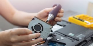 Close up of laptop computer hardware repairing or diagnostic with screwdriver.