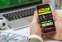 Cropped shot of male hands holding smartphone with bookmaker's mobile application interface design template
