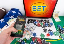 The Psychology of Online Gambling and Financial Decision-Making betting bet sport phone gamble laptop over shoulder soccer live home website concept - stock image