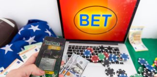 betting bet sport phone gamble laptop over shoulder soccer live home website concept - stock image