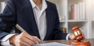 Businessman and lawyer discussing business contract document for legal advice in lawyer's office.