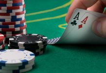 hand raises for two winning cards on a green poker table