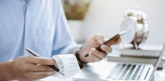 young man holding pen with bills working for calculate business data, taxes, bills payment, Start up counting finance. accounting, statistics, and analytic research concept
