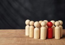Essential HR Strategies for Effective Employee Management Red wooden figures stand out from the crowd of wooden figures