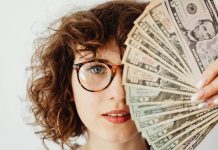 Woman covering her face with money