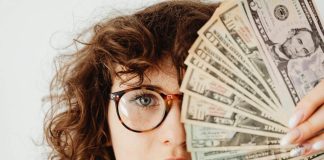 Woman covering her face with money