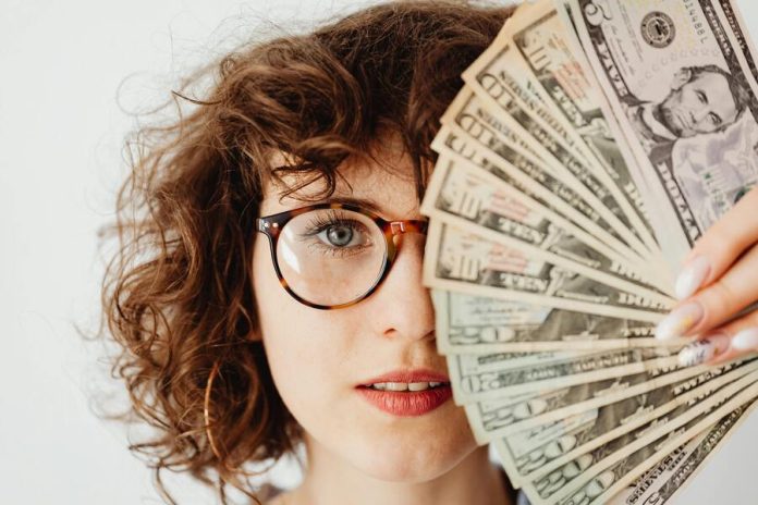 Woman covering her face with money