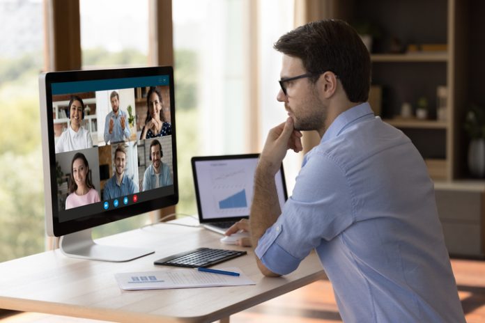 Concentrated millennial manager holding video call with colleagues. Remote Work