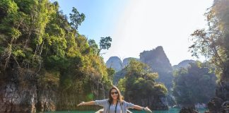 Photo of Woman Sitting on Boat Spreading Her Arms
