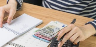 Calculator, notebook and money